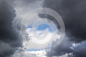 stormy grey and white clouds on blue sky background