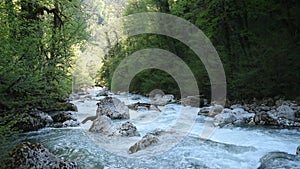 A stormy mountain river blue water flows among the jungle forest