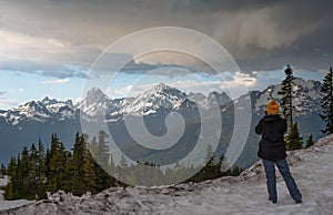 Stormy mountains being captured by a female photographer