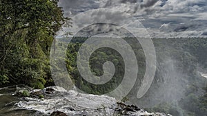 A stormy river collapses from a ledge into an abyss. photo