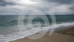 Stormy sea with big waves at stormy rainy day. Ocean against grey cloudy sky. Tropical summer seascape. Beauty and power in nature