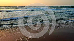 Stormy sea Big waves white foam sea sand backdrop sunset and dawn Slow motion