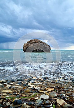 Stormy sea and mistical rock photo