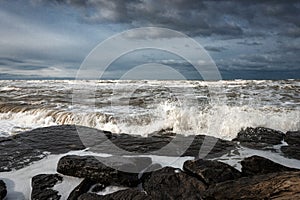 Stormy sea, the waves break on rocks