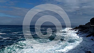 Stormy sea waves near a rocky shore