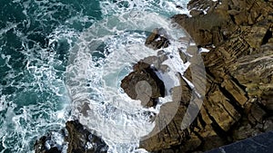 Stormy sea waves near a rocky shore