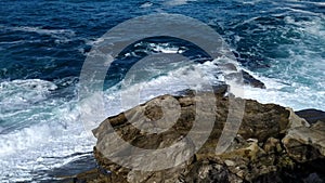 Stormy sea waves near a rocky shore