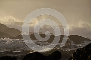 Stormy sea waves at sunset