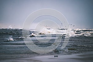 Stormy sea in winter with white waves crushing - vintage film lo