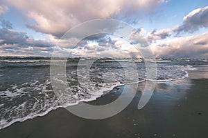 Stormy sea in winter with white waves crushing - vintage film lo