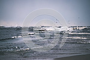 Stormy sea in winter with white waves crushing - vintage film lo