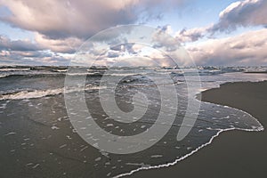 Stormy sea in winter with white waves crushing - vintage film lo