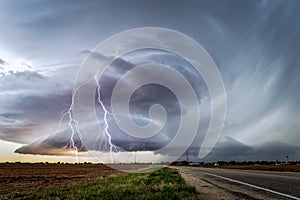 Stormy sky with supercell thunderstorm and lightning bolts photo