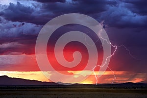 Stormy sky with lightning strike at sunset