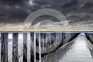 stormy sky over breakwater on North sea