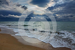 stormy sky over sea and sandy beach