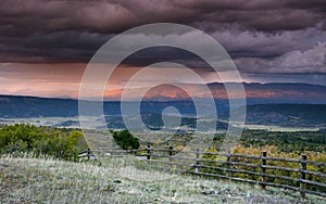 Stormy sky at sunset over San Juan Mountain range and Autumn Fall color of the Dallas Divide Ridgway Colorado