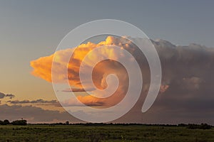 Stormy sky at sunset in the pampas field, photo