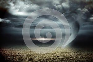 Stormy sky with tornado over field