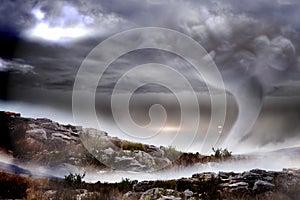 Stormy sky with tornado over landscape