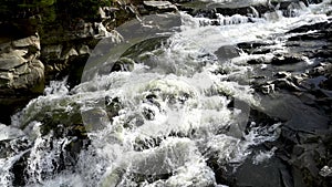 Stormy stream of water in Ukrainian Carpathians at the Probiy waterfall. Crystal pure water