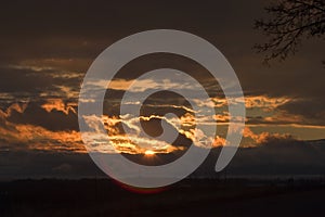 Stormy sunset over Utah Lake with lens flare