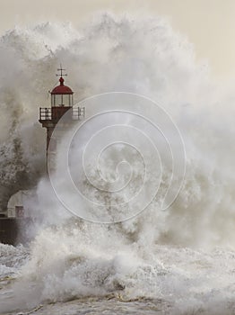 Stormy wave splash covering old lighthouse