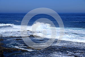 Stormy waves breaking on the stony beach in Fuerteventura in Jandia Natural Park