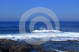 Stormy waves breaking on the stony beach in Fuerteventura in Jandia Natural Park