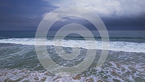 Stormy waves and dramatic storm clouds over sea