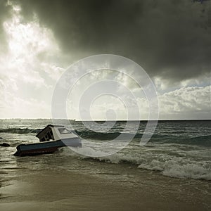 Stormy weather and fishing boat stranded on a beach