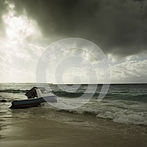 Stormy weather and fishing boat stranded on a beach photo