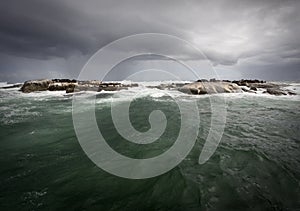 Stormy weather on the ocean with an island