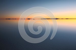 Beautiful sunset and afterglow reflection Uyuni salt flats