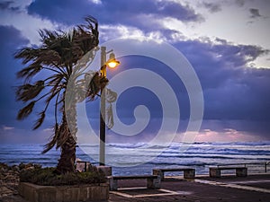 Stormy wind weather on the shores of the Mediterranean Sea, twilight, burning lantern.