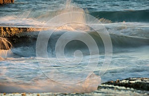 Stormy windy sea waves splashing on a rocky seashore