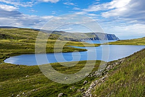 Storvatnet lake in Mageroya island. The coastline of the Barents Sea in Nord Cape direction is at background. Nordkapp