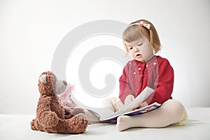 Story time. Little girl playing school with toys teddy bear and doll.  children education and development, happy childhood