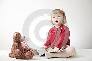 Story time. Little girl playing school with toys teddy bear and doll.  children education and development, happy childhood