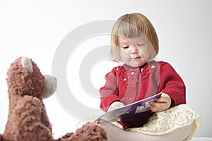 Story time. Little girl playing school with toys teddy bear and doll.  children education and development, happy childhood