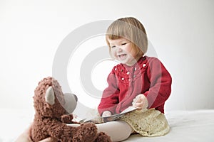 Story time. Little girl playing school with toys teddy bear and doll.  children education and development, happy childhood