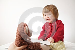 Story time. Little girl playing school with toys teddy bear and doll.  children education and development, happy childhood