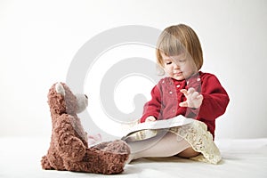 Story time. Little girl playing school with toys teddy bear and doll.  children education and development, happy childhood