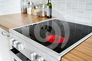 Stove and cooker red hot. Induction, ceramic cooktop, electric stovetop and hob in kitchen. Warm plate ready for cooking.