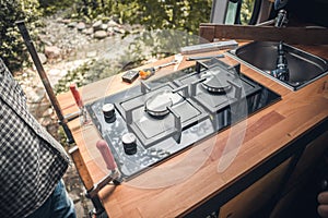 Stove getting installed into a camper van