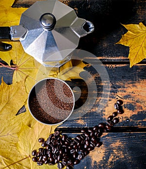 Stove top espresso maker and dark roast coffee for the autumn weather photo