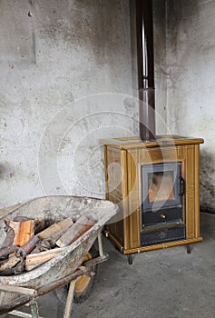 Stove and wheelbarrow full of firewood