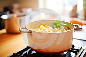 stovetop pot full of creamy mac and cheese