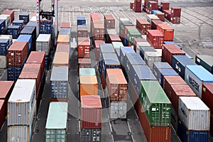 Stowed containers in a rows from different shippers on the pier of container cargo terminal