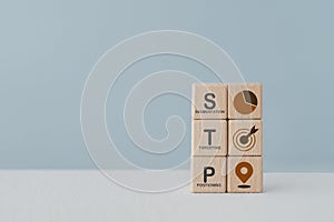 STP text ,abbreviation for Segmentation, Targeting, Positioning, and icon on wooden cube blocks. For marketing analysis, customer